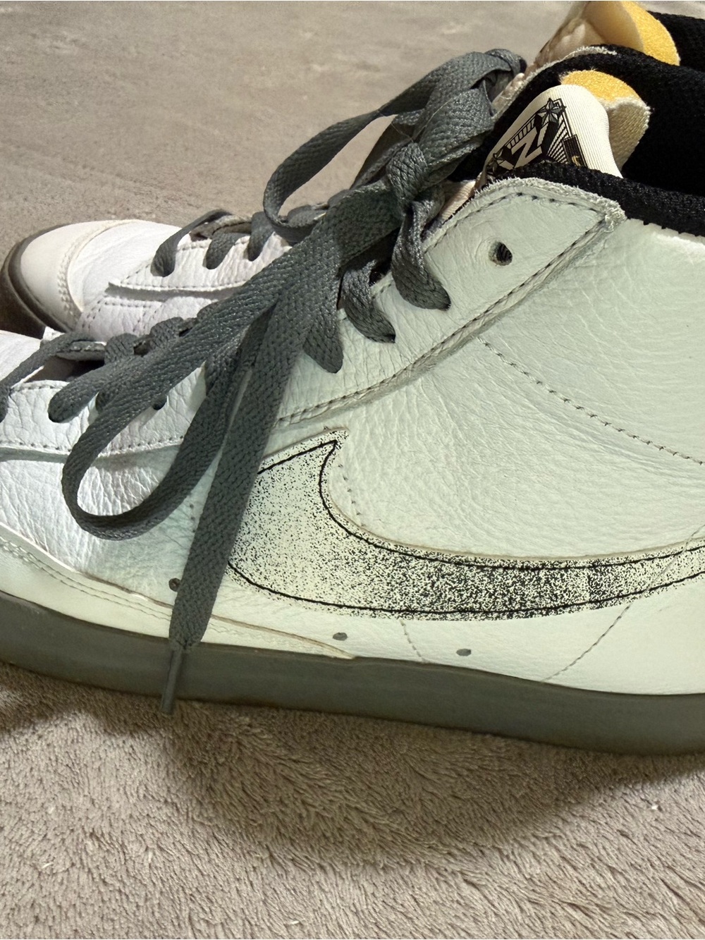 Nike White High-Top Sneakers with Gray Laces and Black Speckled Swoosh